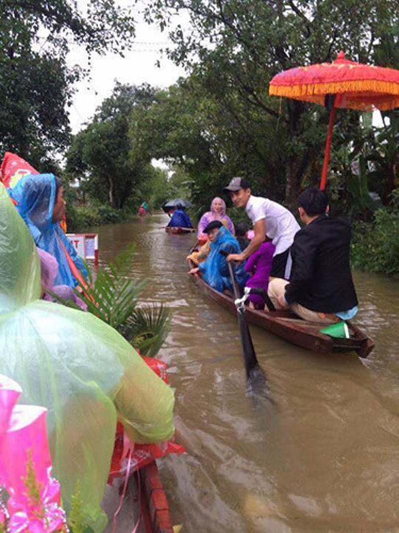  Thậm chí, mưa lớn dường như không phải là trở ngại của cặp đôi này mà còn trở thành yếu tố tạo nên kỷ niệm đáng nhớ của họ. Họ hàng hai bên cùng cô dâu chú rể đều xắn quần cao tới đầu gối, không đi giày.