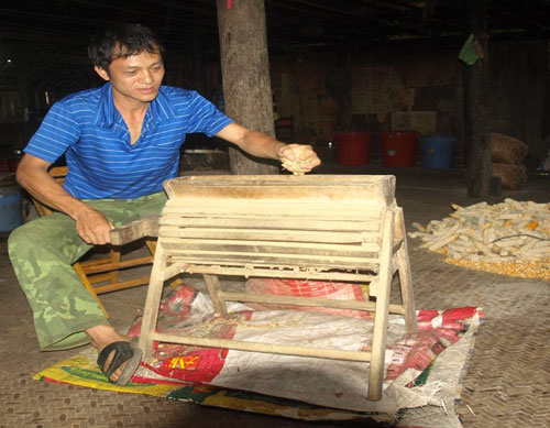 Anh Vương Hùng Nam bên chiếc máy bóc lạc quay tay bằng gỗ. Ảnh: Báo Cao Bằng. Anh Vương Hùng Nam bên chiếc máy bóc lạc quay tay bằng gỗ. Ảnh: Báo Cao Bằng.
