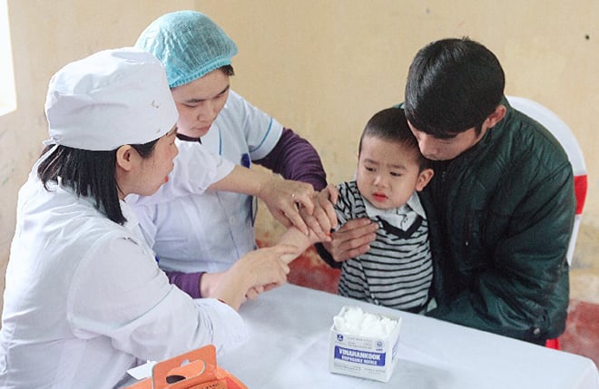 Lấy mẫu máu em bé để xét nghiệm tìm giun sán. Lấy mẫu máu em bé để xét nghiệm tìm giun sán.