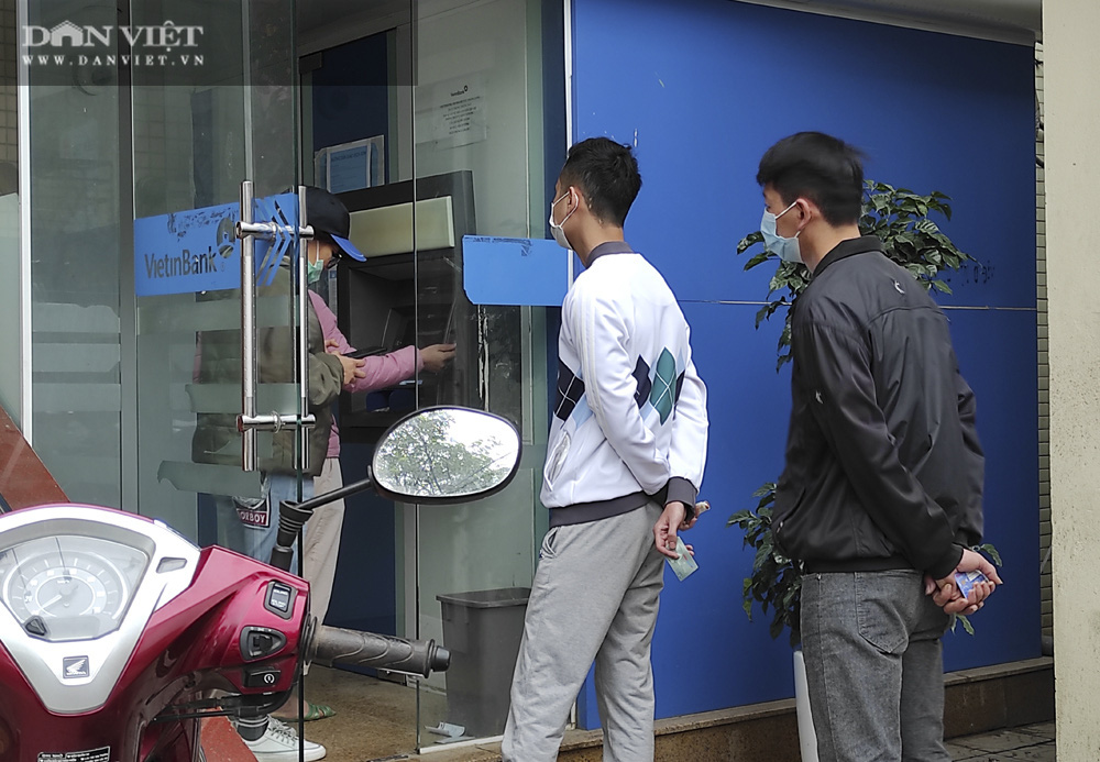 Công nhân đội mưa, xếp hàng dài rút tiền ở cây ATM ngày cận Tết Nguyên đán 2021 - Ảnh 13.