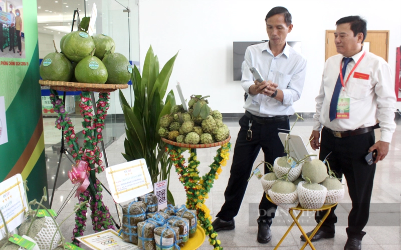 Khách hàng dùng điện thoại truy xuất nguồn gốc sản phẩm Ocop của huyện Phú Giáo. Ảnh: Trần Khánh